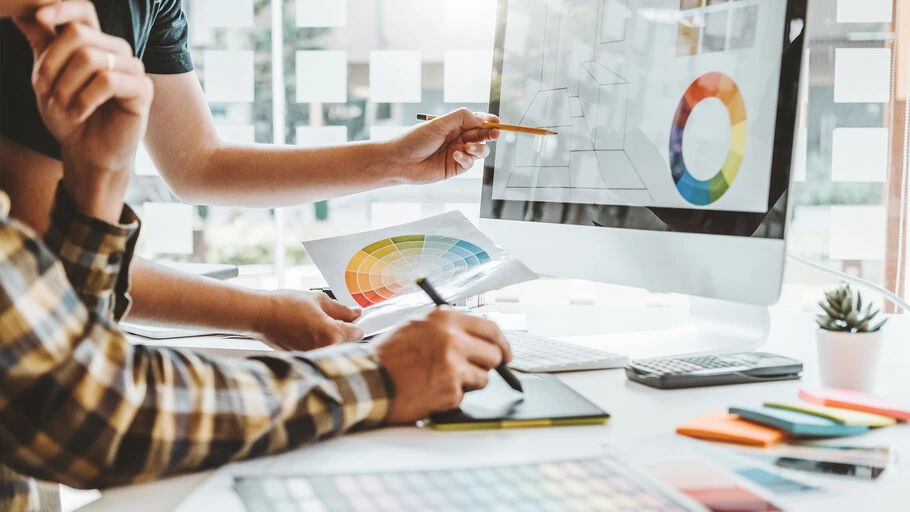 Professional businesswoman analyzing data charts on digital tablet in modern office setting.